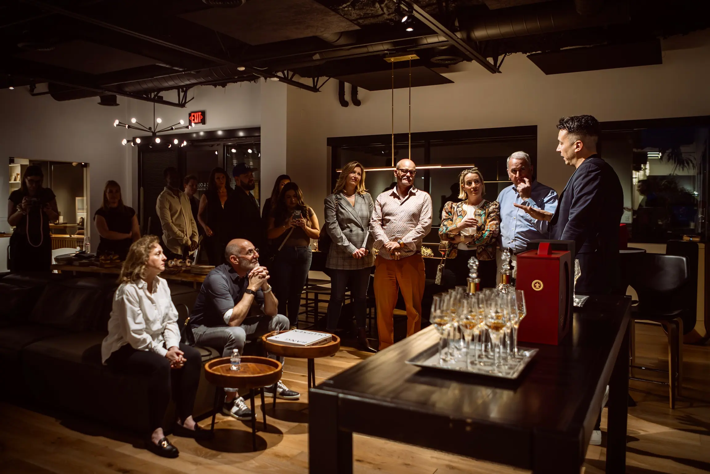 Guests gather among the displays at an evening event in the Bang & Olufsen Scottsdale showroom