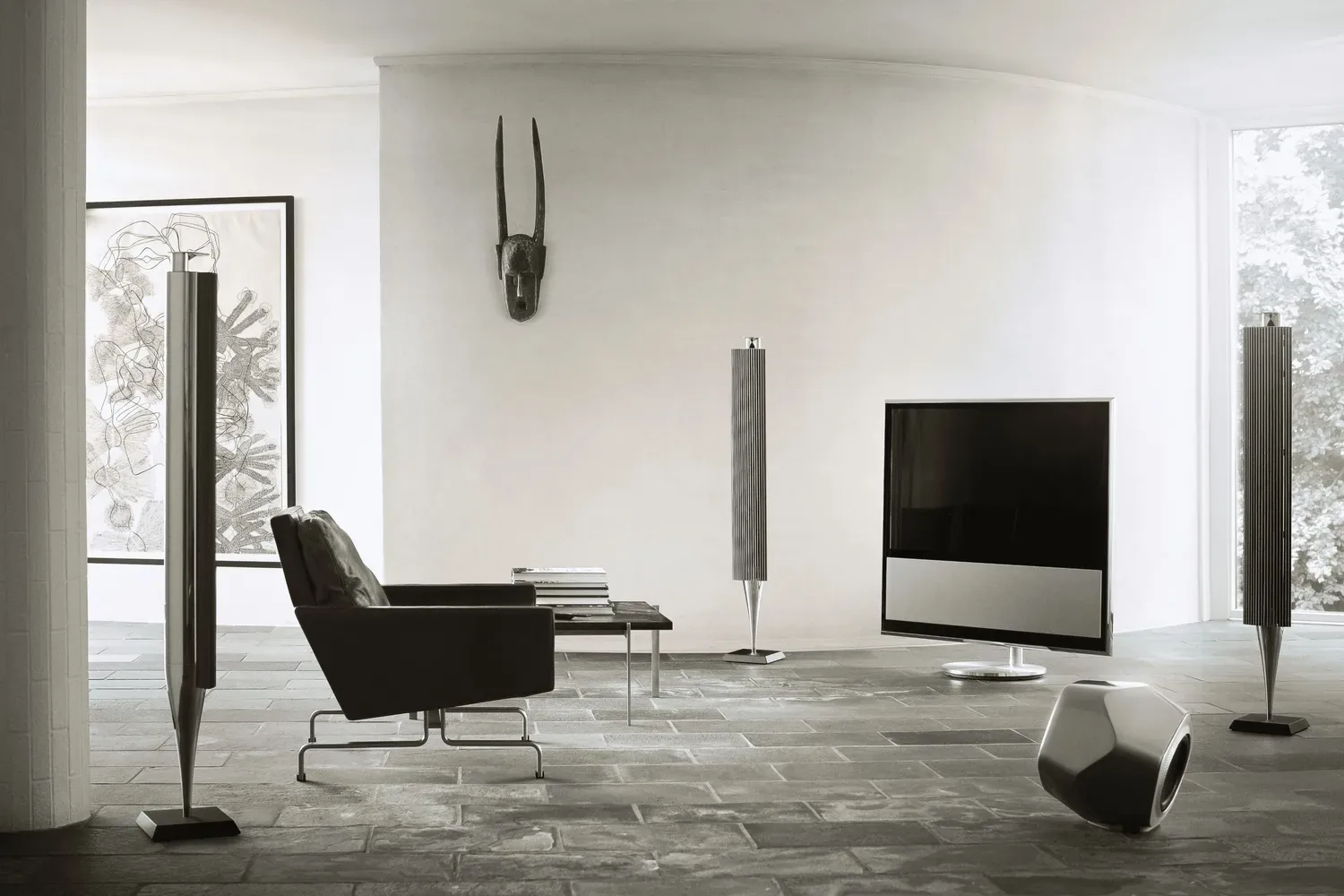 Bang & Olufsen Beolab 18 speakers, a Beovision television and a Beolab 19 subwoofer in a white living room
