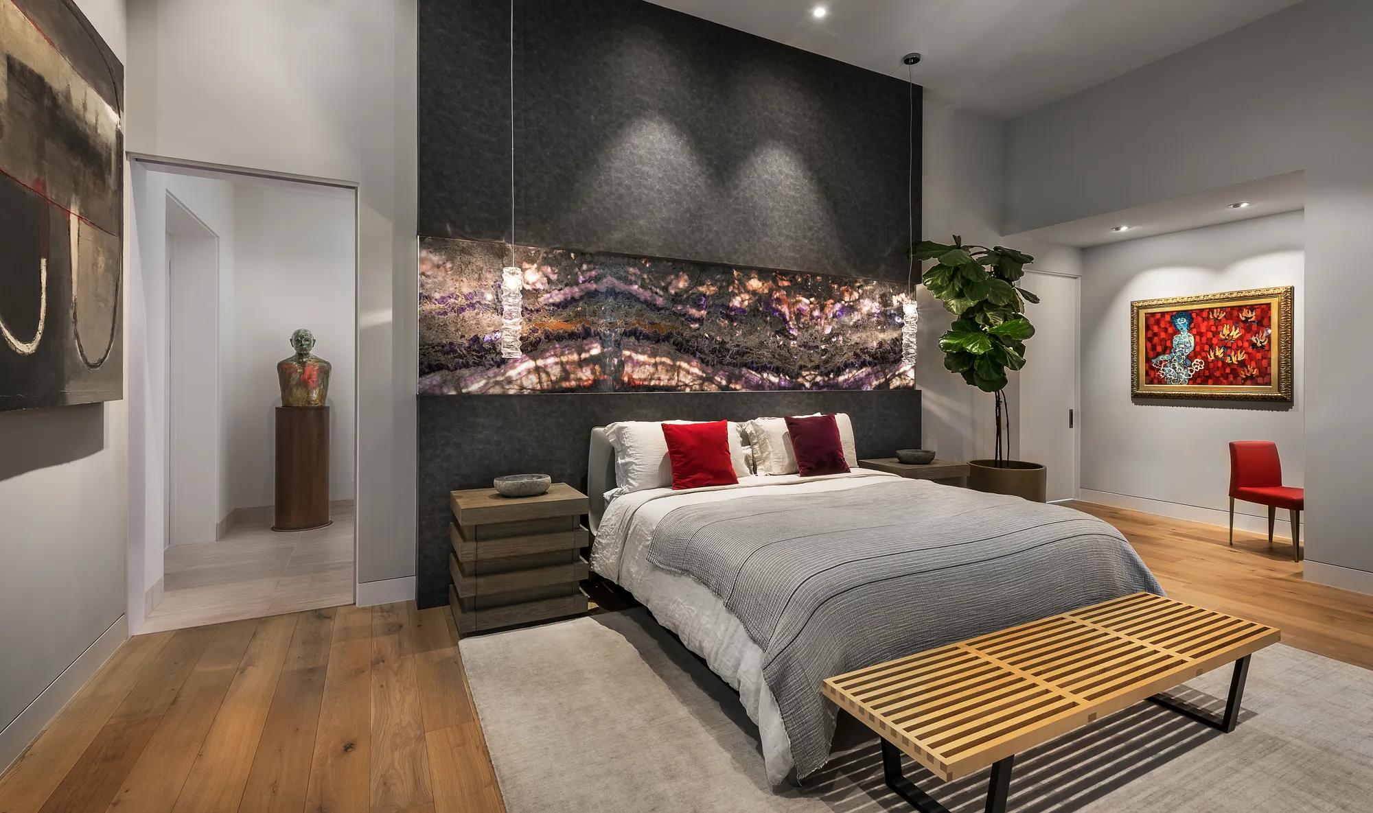 Master bedroom with LED-backlit stone feature wall and picture-lit artwork