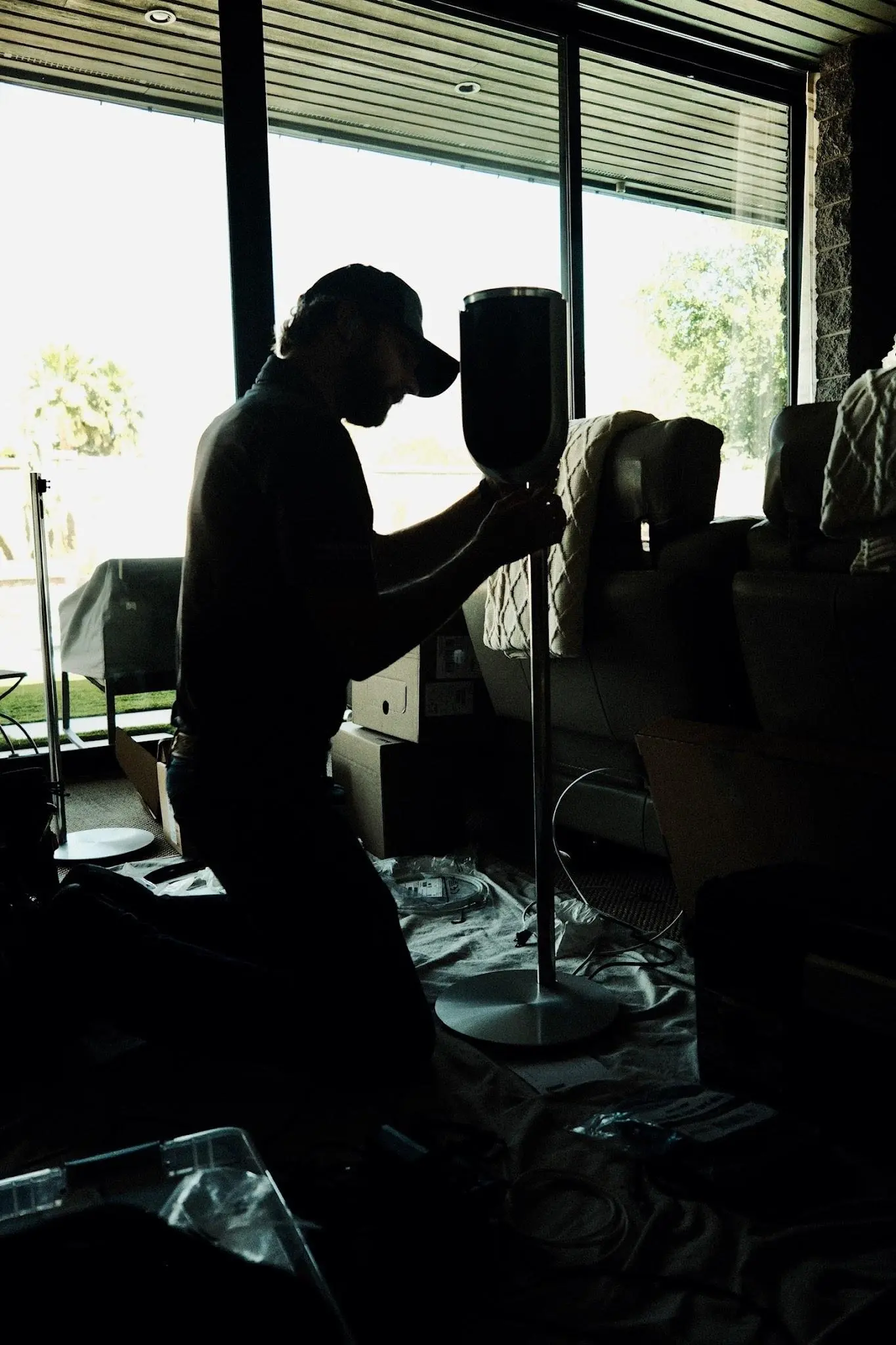 A Watt Integration technician positions a Beolab speaker during the Fogerty whole-home installation