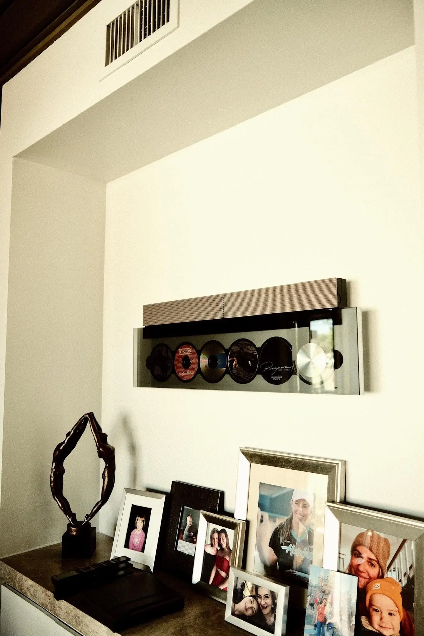 Beosound Level resting on the entry shelf among framed family photographs in the Fogerty home