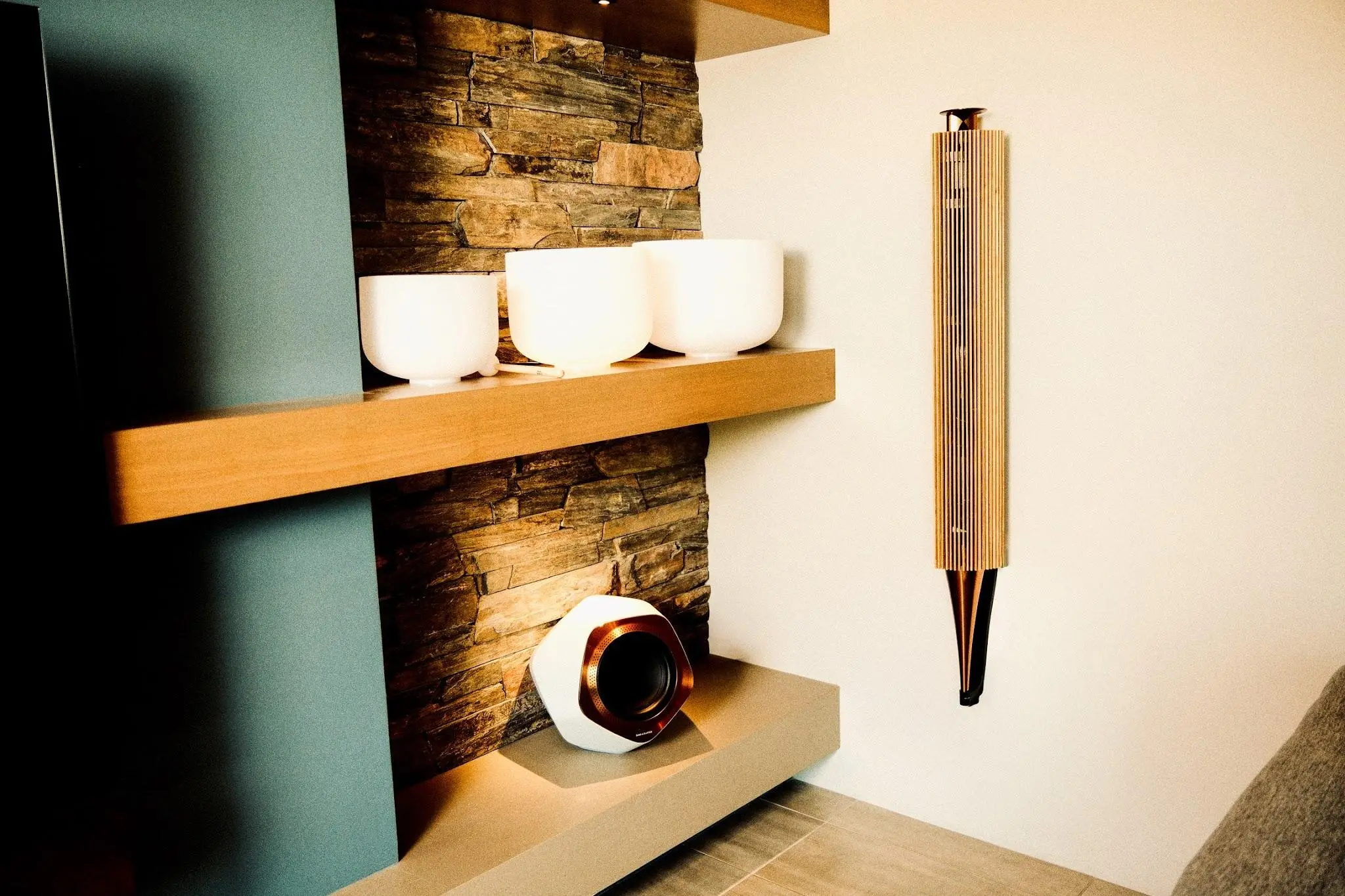 Bang & Olufsen Beolab 18 against a stacked-stone wall with open shelving in a Sedona great room